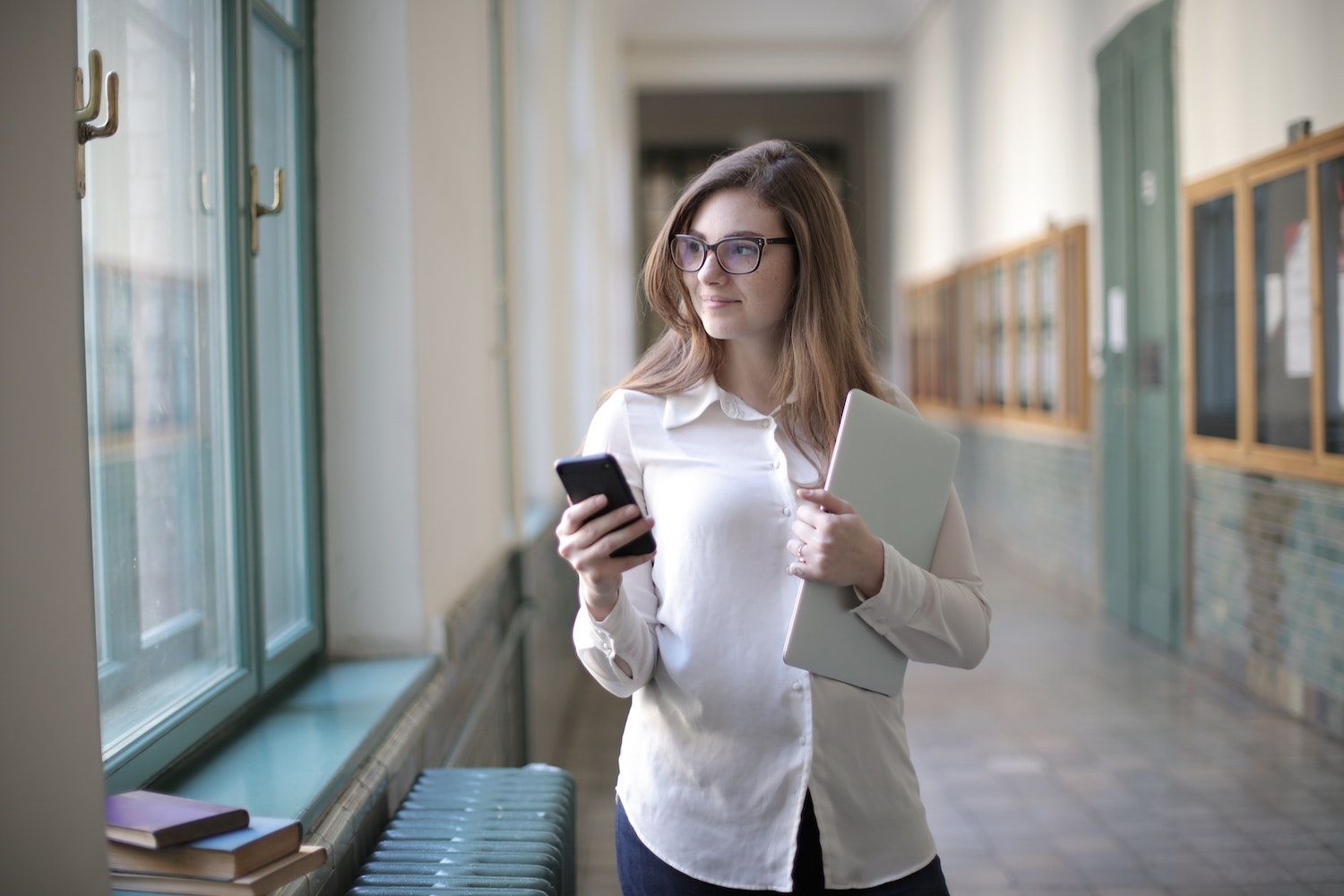 woman holding phone in hallway