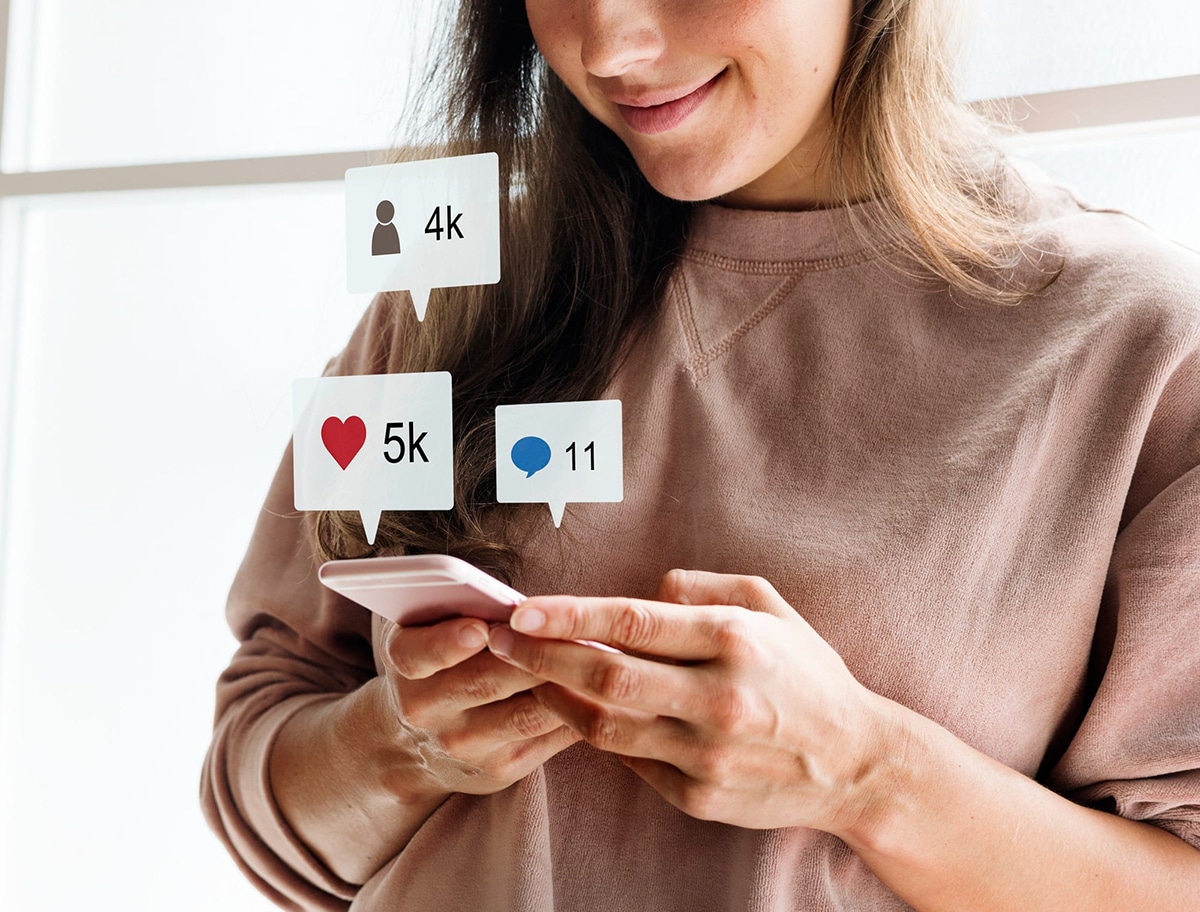 Woman checking social media apps on her smartphone