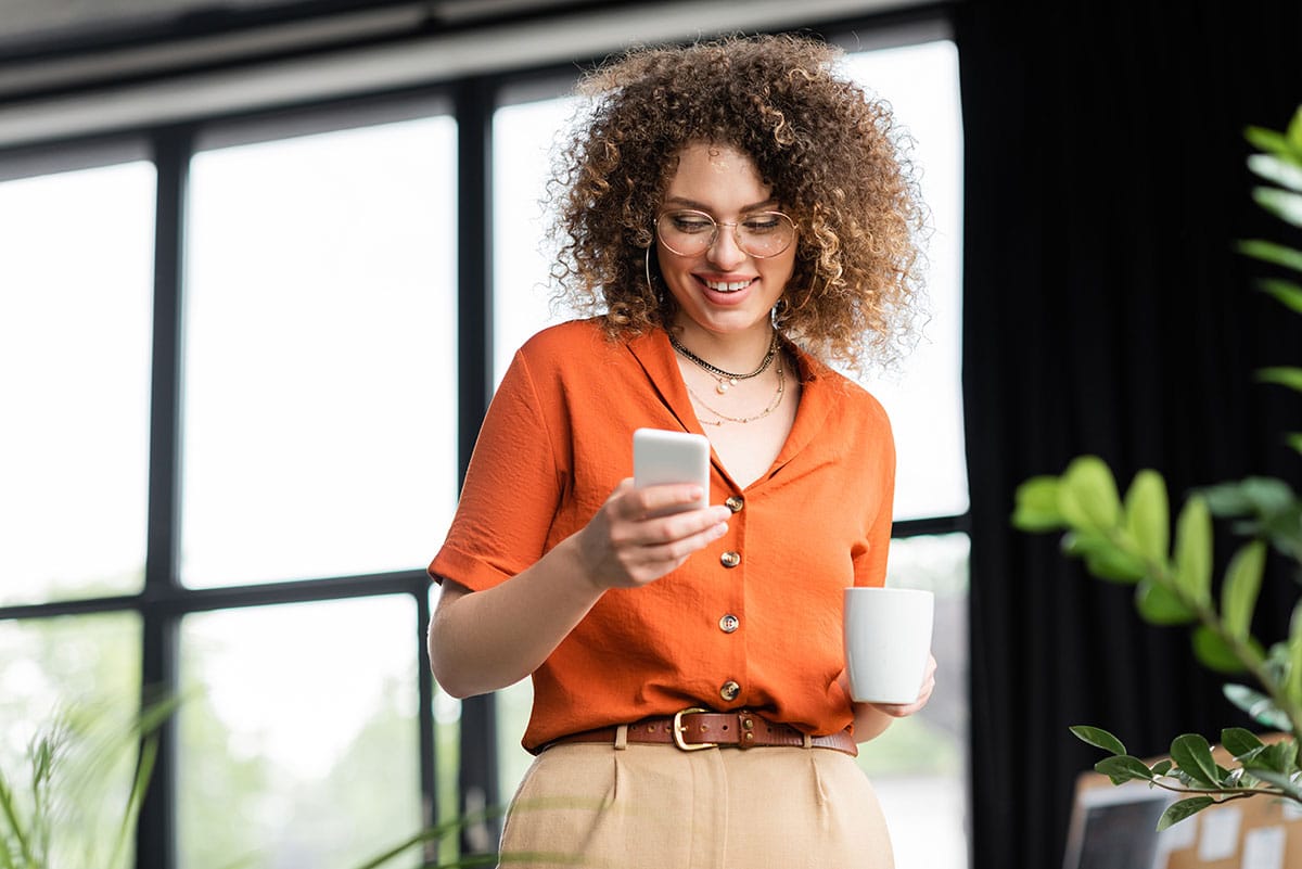 Woman using phone for enterprise SMS solutions
