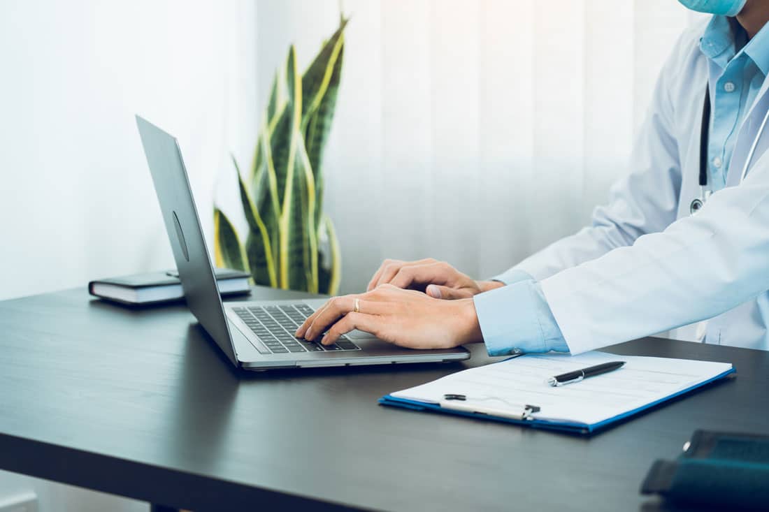 Doctors office sending a HIPPA compliant text message from a laptop