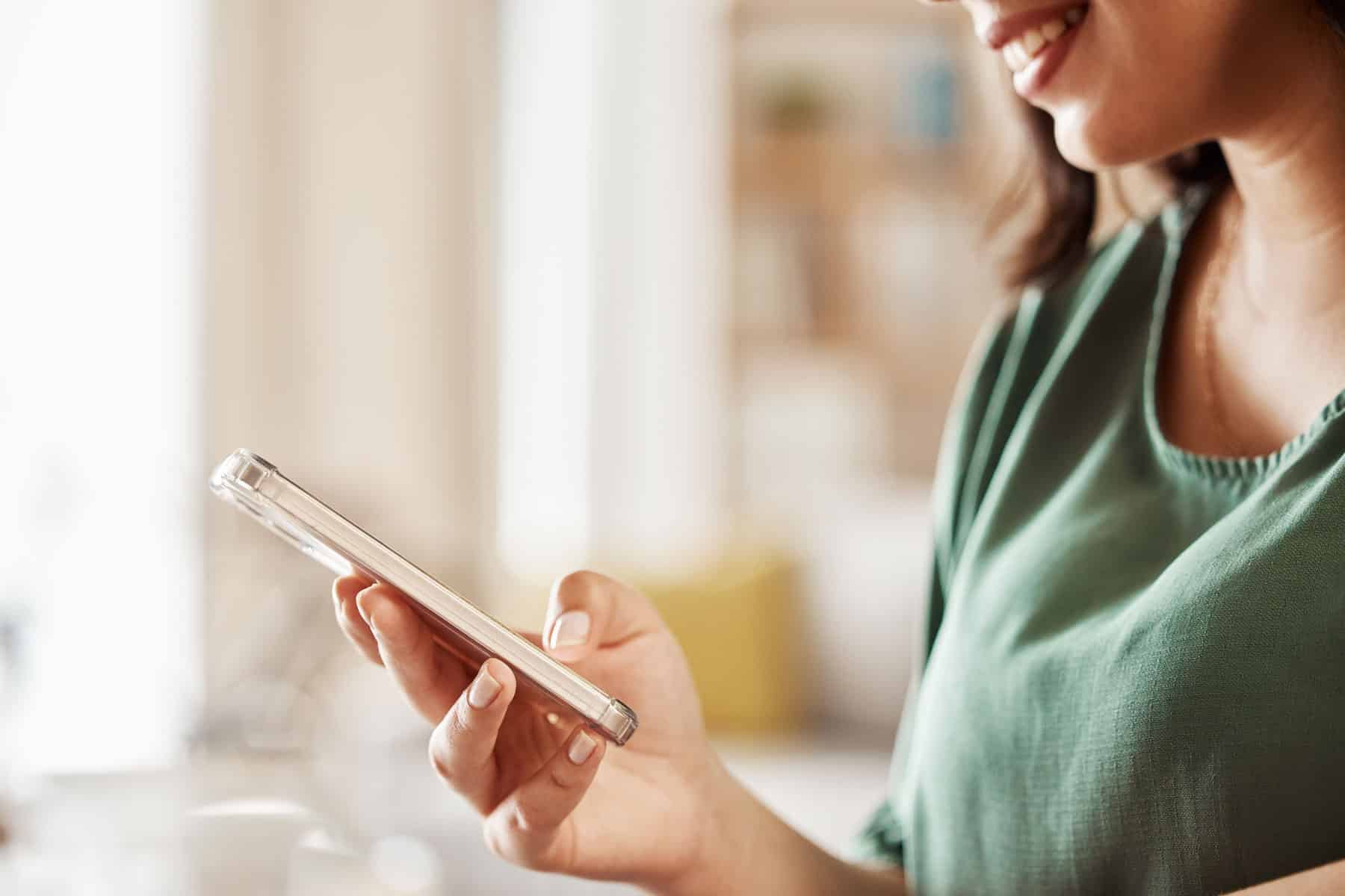 Woman sending text to email from her phone