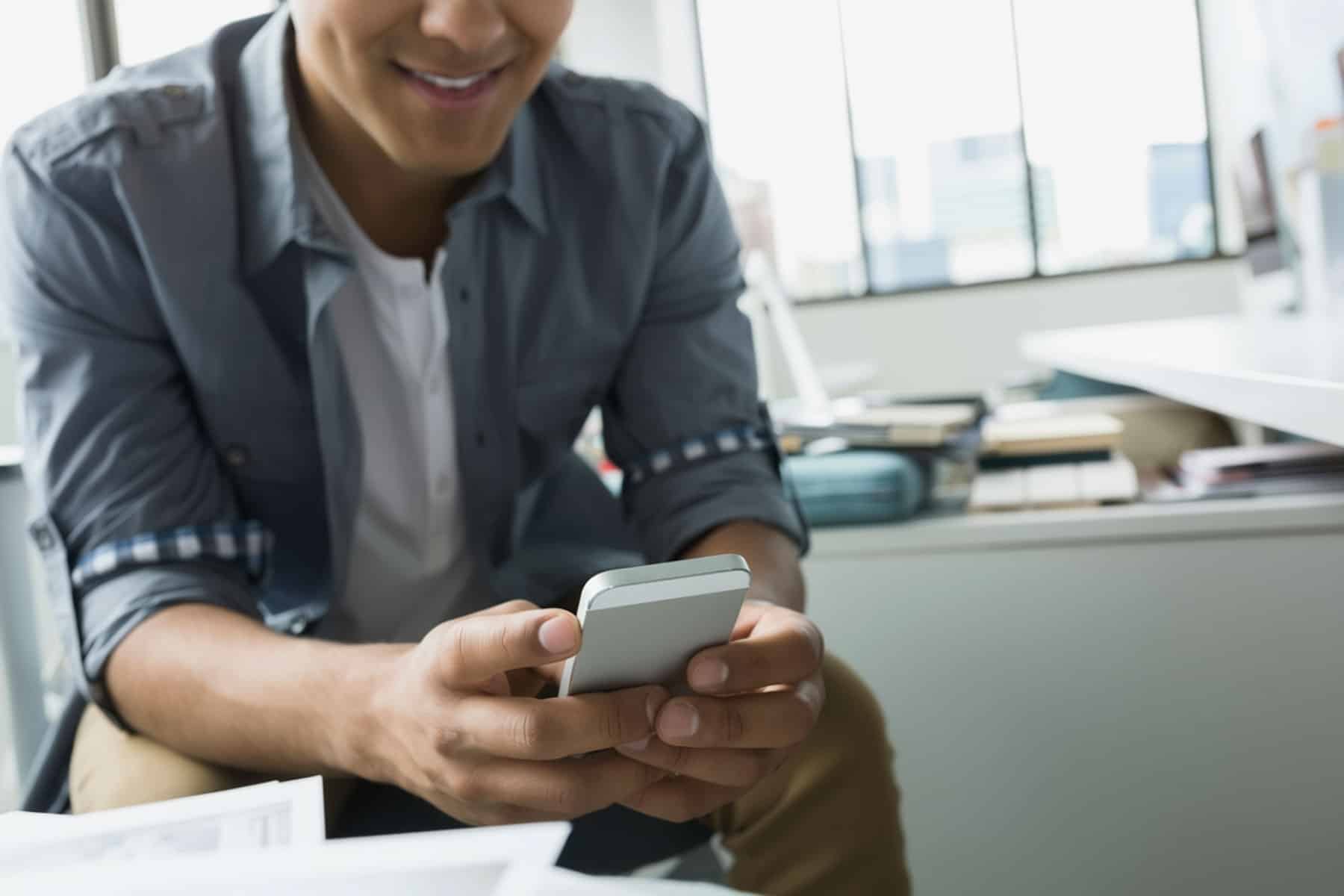 Man sending text to email on his phone