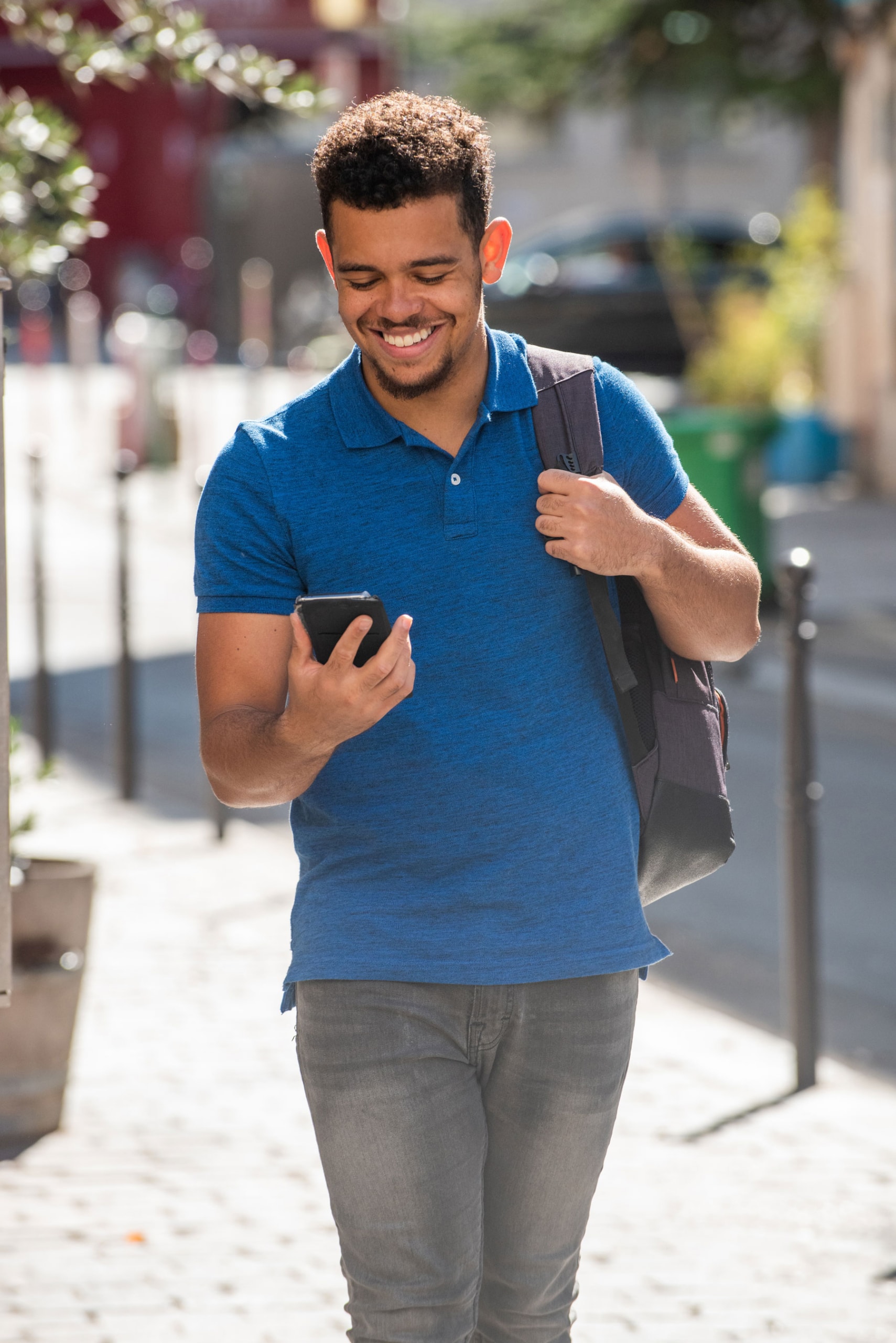 Man receiving appointment reminder drip campaign on phone while walking outside