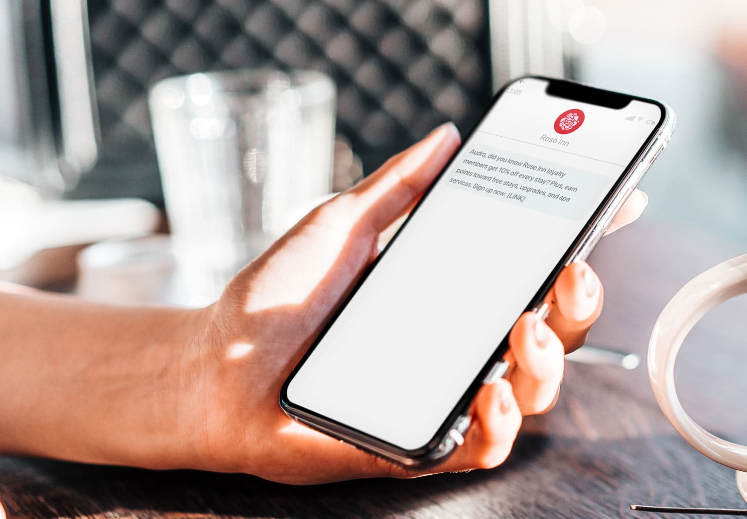 Woman receiving sms marketing message from a hotel