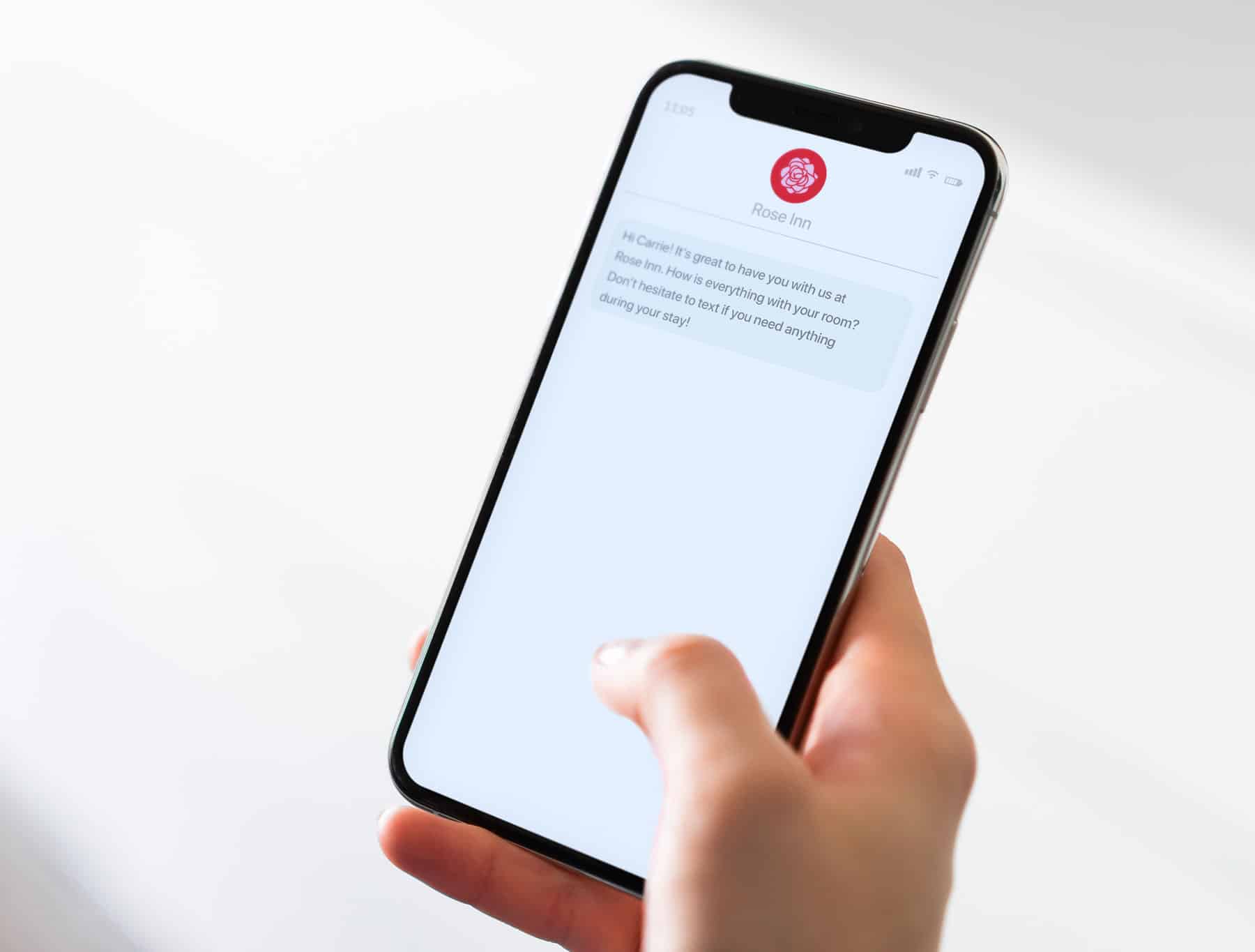 Woman receiving sms marketing message checking in with her about her hotel room