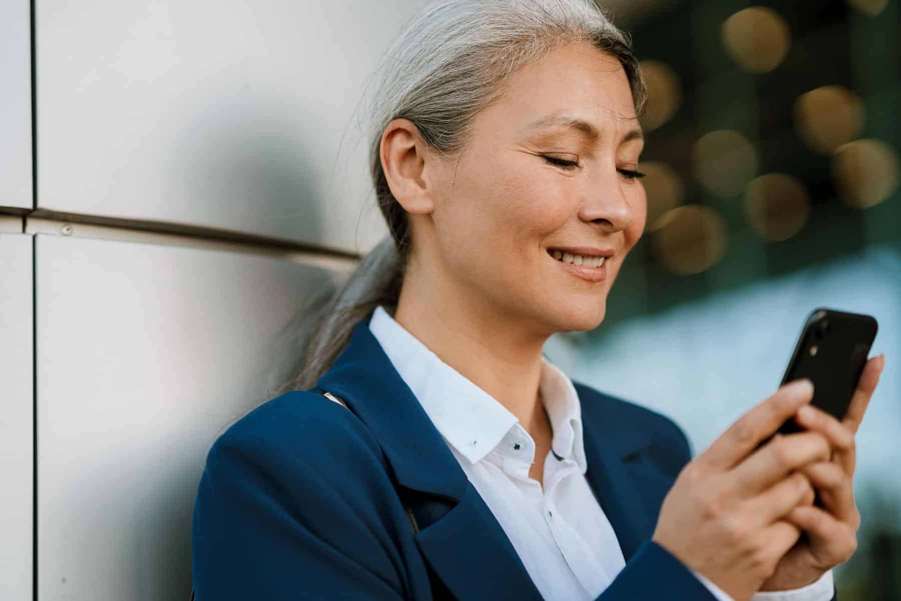 A woman reading a text message sent to rebuild customer trust