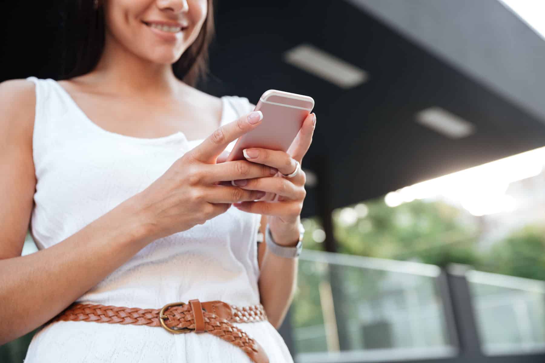 Woman reading an RCS message with positive response rate to measure rcs success