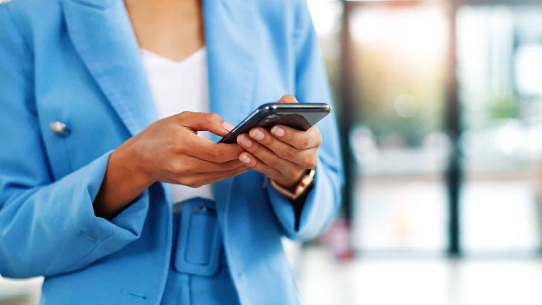 RCS message received on phone by woman in a blue suit