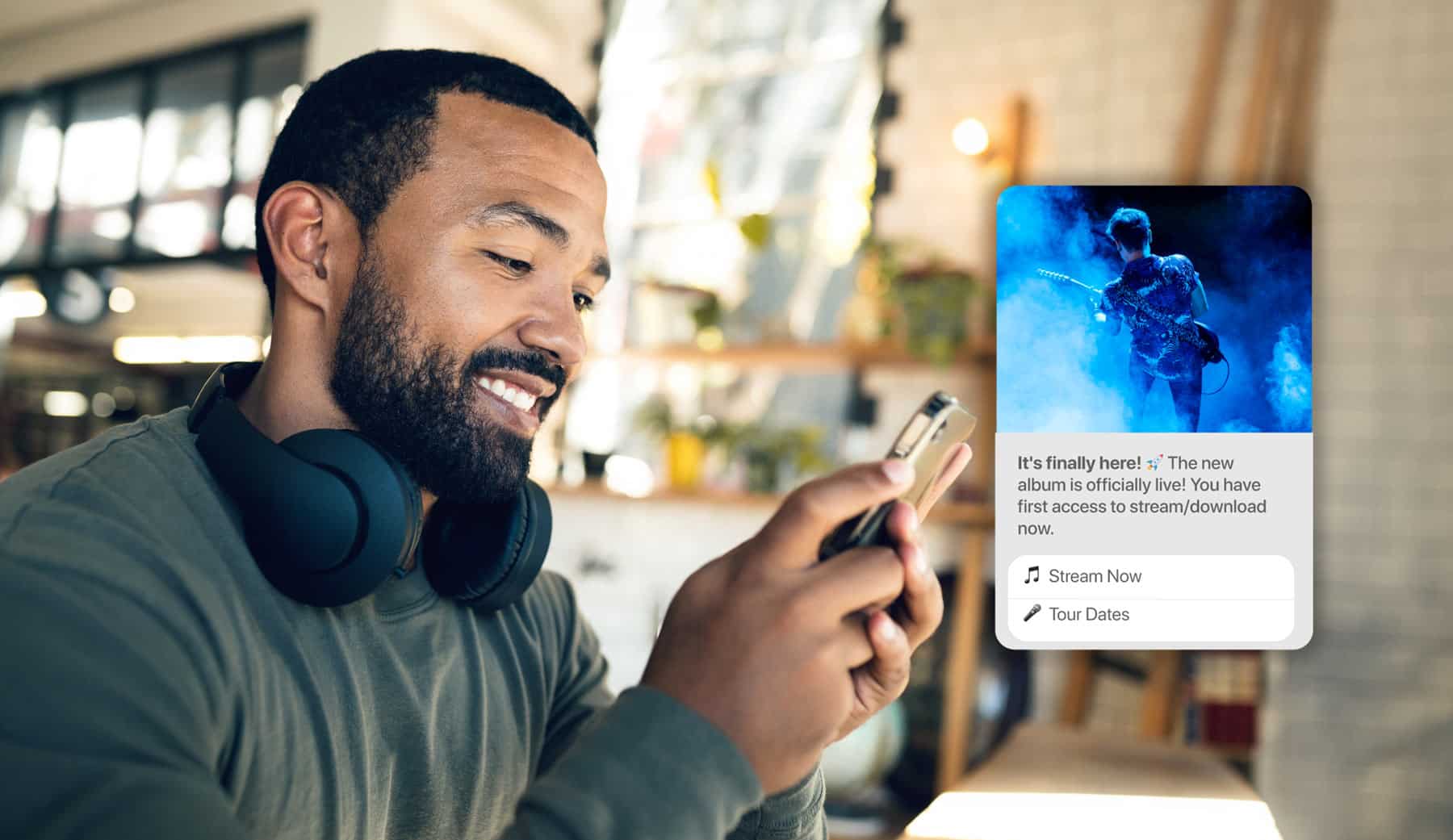 Man receiving a message on his phone about an album from an RCS verified sender