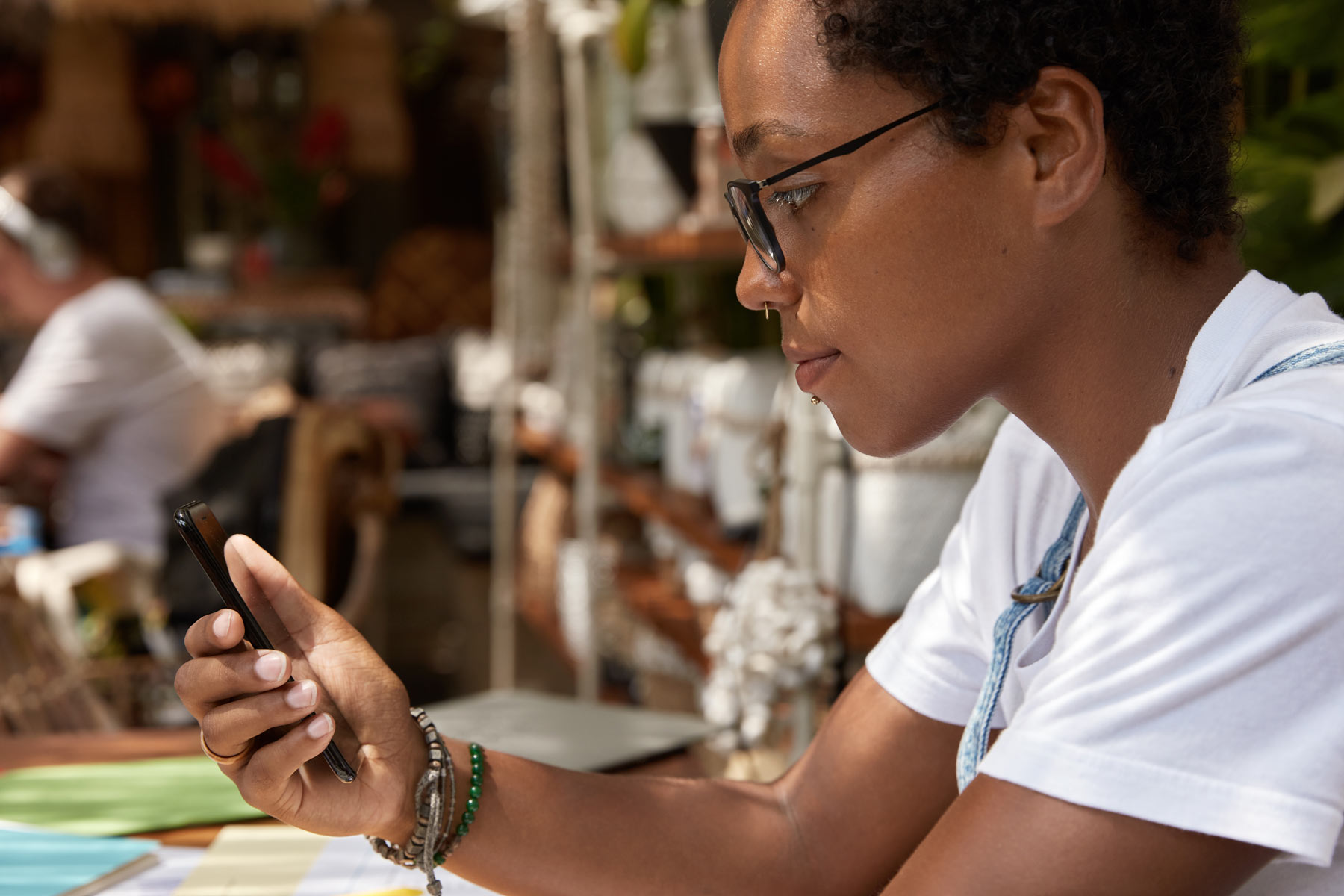 Thoughtful person reading RCS message on phone