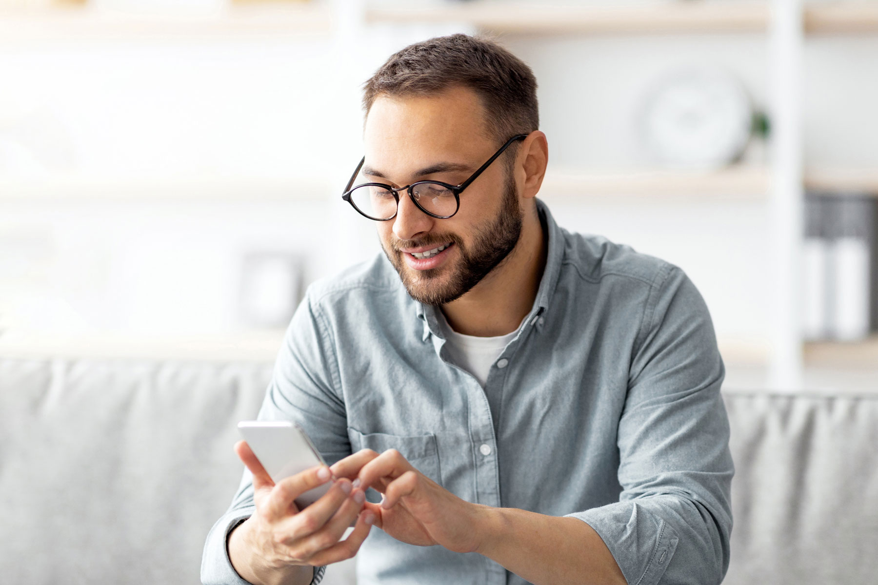 Man reading RCS message on his phone